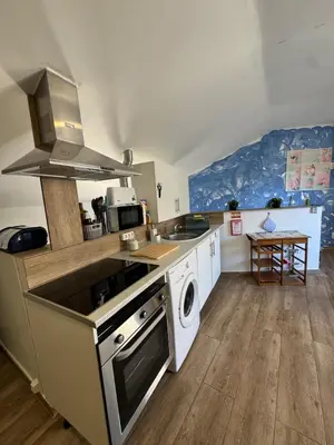 a kitchen with a sink and a stove top oven at House in the Heart of Funchal with big balcony in Funchal
