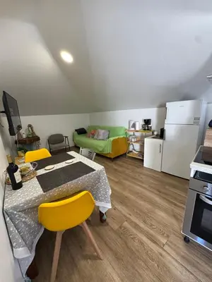 a kitchen with a table and yellow chairs in a room at House in the Heart of Funchal with big balcony in Funchal