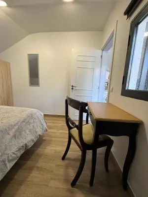 a bedroom with a desk and a bed and a table at House in the Heart of Funchal with big balcony in Funchal