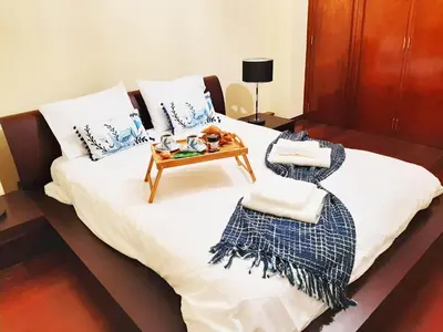 a bed with a table and towels on it at Funchal Old Town Flat 1 in Funchal