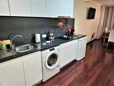 a kitchen with a washing machine and a sink at Funchal Old Town Flat 1 in Funchal