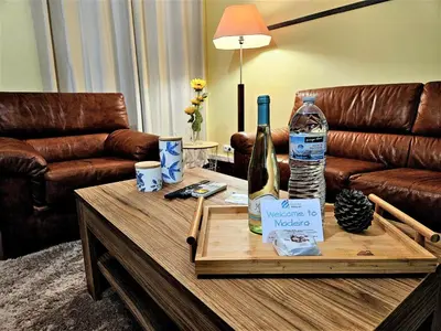 a room with a table with a bottle of wine at Funchal Old Town Flat 1 in Funchal