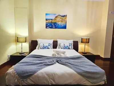 a bedroom with a bed with two towels on it at Funchal Old Town Flat 1 in Funchal