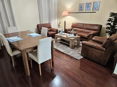 a living room with a table and a couch at Funchal Old Town Flat 1 in Funchal