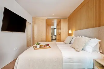 a bathroom with a white toilet and a mirror at Exclusive Terrace Apartment at Savoy Insular in Funchal