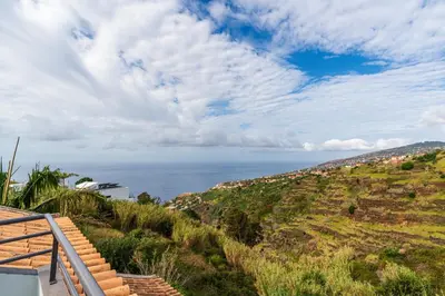 a view of the ocean from a house at Ribeiro´s House, New apartment with amazing sunsets in Arco da Calheta