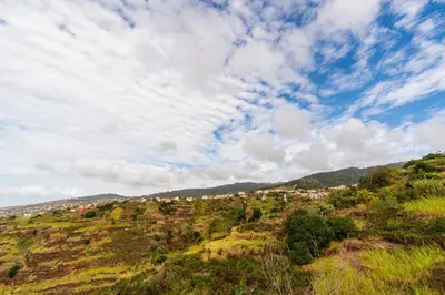 a view of a hill with a city on it at Ribeiro´s House, New apartment with amazing sunsets in Arco da Calheta