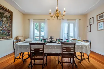 a dining room with a table and chairs at Villa Magnólia in Funchal