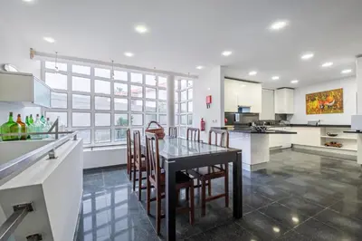 a kitchen with a table and chairs in a kitchen at Villa Magnólia in Funchal
