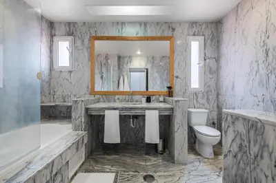 a bathroom with a tub and a sink and a toilet at Villa Magnólia in Funchal