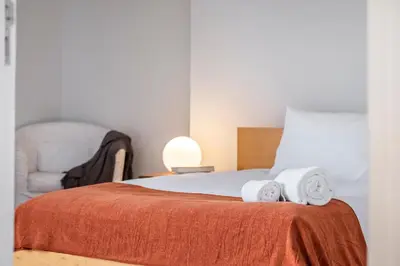 a bedroom with a bed with two towels on it at Villa Magnólia in Funchal
