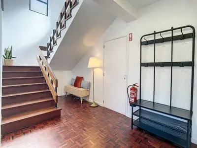 a living room with a staircase and a chair at Casa Santa Rita by Atlantic Holiday in Funchal