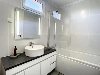 a white bathroom with a sink and a shower at Casa Santa Rita by Atlantic Holiday in Funchal