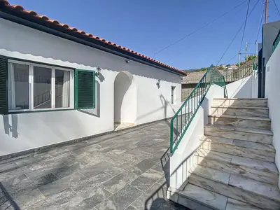 a staircase leading to a house with green shutters at Casa Santa Rita by Atlantic Holiday in Funchal