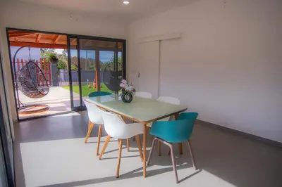 a dining room with a table and chairs at Villa Rosa in Porto Moniz