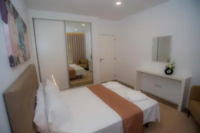 a hotel room with a bed and a mirror at Villa Rosa in Porto Moniz