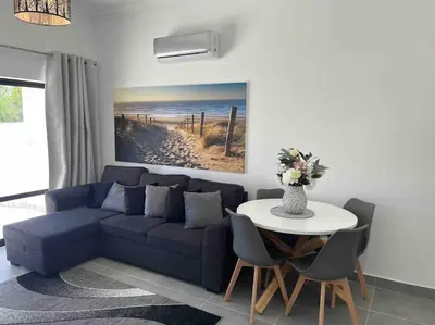a living room with a blue couch and a table at Cantinho de Sagres in Sagres