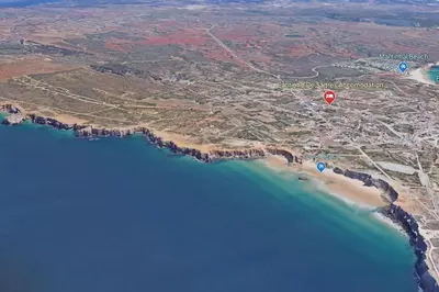 a red balloon is flying over the water at Cantinho de Sagres in Sagres