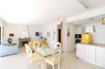 a kitchen and dining room with a table and chairs at Villa Sea Shore by Villa Plus in Gaula