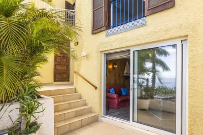 a house with a sliding glass door with a red chair at Villa Sea Shore by Villa Plus in Gaula