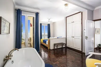 a bathroom with a tub and a bedroom with a bed at Villa Sea Shore by Villa Plus in Gaula