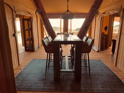 a dining room table and chairs in a room at Quinta Aurora in Burgau