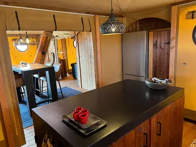 a kitchen with a counter with red cups on a tray at Quinta Aurora in Burgau