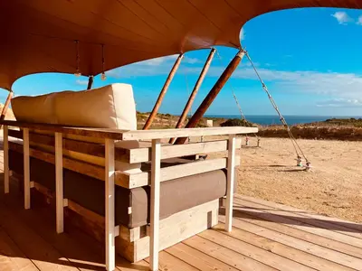 a bed in a tent on the beach at Quinta Aurora in Burgau