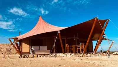 a tent with chairs and a table in the desert at Quinta Aurora in Burgau