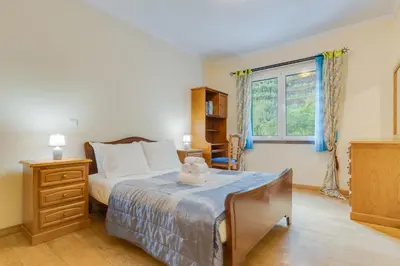 a bedroom with a bed with a teddy bear on it at Isabel Apartment by Holiday Rental Madeira in Ribeira Brava