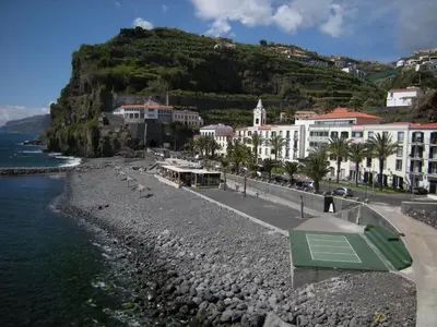a view of a beach with buildings and a mountain at Isabel Apartment by Holiday Rental Madeira in Ribeira Brava