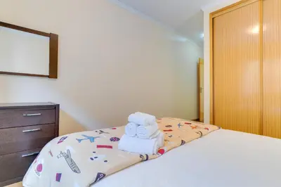 a bedroom with a bed with towels and a dresser at Isabel Apartment by Holiday Rental Madeira in Ribeira Brava