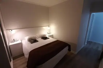 a bedroom with a bed with two pillows on it at Santo António Guest Apartment in Funchal
