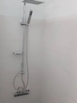 a shower with a shower head in a bathroom at Santo António Guest Apartment in Funchal