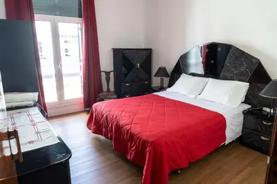 a bedroom with a large bed with a red blanket at City Heart Funchal in Funchal