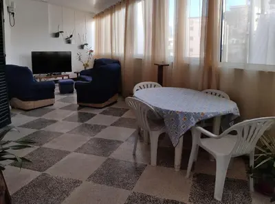 a living room with a table and chairs and a tv at City Heart Funchal in Funchal