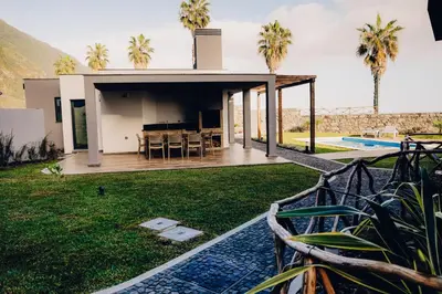 a villa with a swimming pool and a house at Casas do Calhau Miúdo - Seixal in Seixal