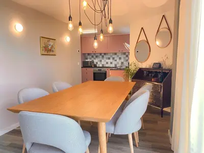 a dining room with a wooden table and chairs at Myrtus - House with sea view and garden in Funchal