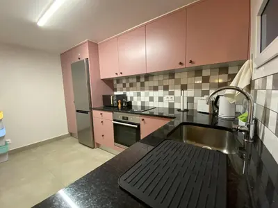 a kitchen with pink cabinets and a sink at Myrtus - House with sea view and garden in Funchal