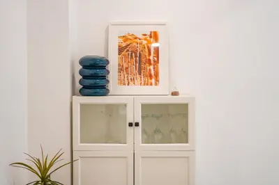 a white cabinet with a picture on top of it at Os Fragosinhos II by Amazing Madeira in Funchal