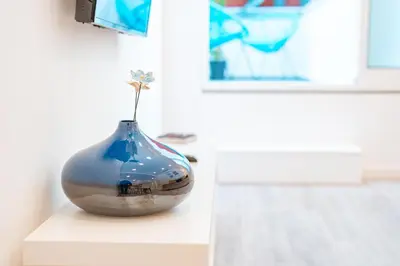 a blue and white vase sitting on a table at Os Fragosinhos II by Amazing Madeira in Funchal