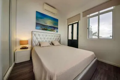 a bedroom with a large bed and a window at Lombo do Doutor Cottage 1 by Mth in Calheta