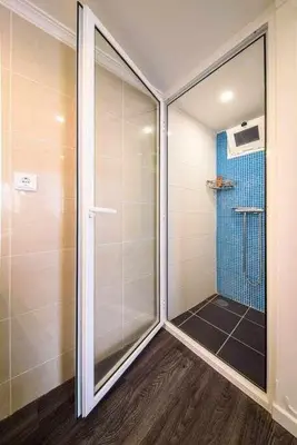 a walk in shower with a glass door in a bathroom at Lombo do Doutor Cottage 1 by Mth in Calheta
