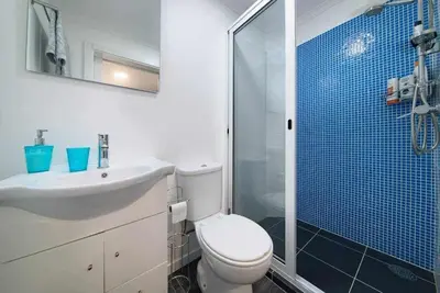 a bathroom with a toilet and a sink and a shower at Lombo do Doutor Cottage 2 by Mth in Calheta