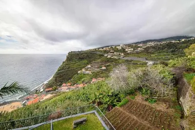 a village on a hill next to the ocean at Lombo do Doutor Cottage 2 by Mth in Calheta