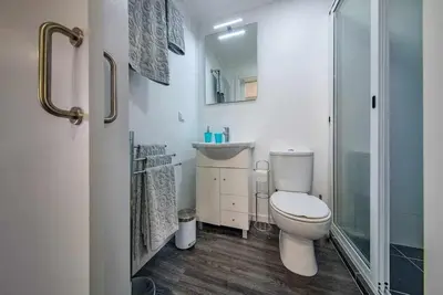 a bathroom with a toilet and a sink and a shower at Lombo do Doutor Cottage 2 by Mth in Calheta