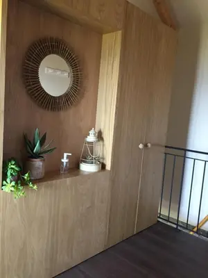 a room with a wooden door with a mirror at Chalet Tropical in Arco da Calheta
