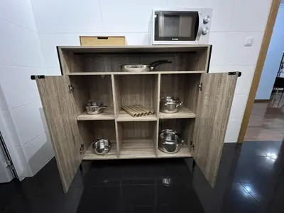 a cabinet in a kitchen with a microwave at Atlantic Dream Alto Mar in Garajau