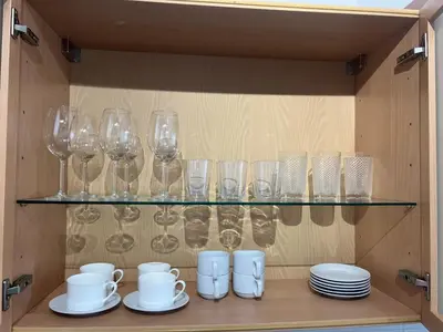 a cupboard with glasses and plates on a shelf at Atlantic Dream Alto Mar in Garajau