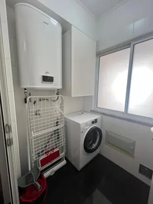 a laundry room with a washing machine and a window at Atlantic Dream Alto Mar in Garajau